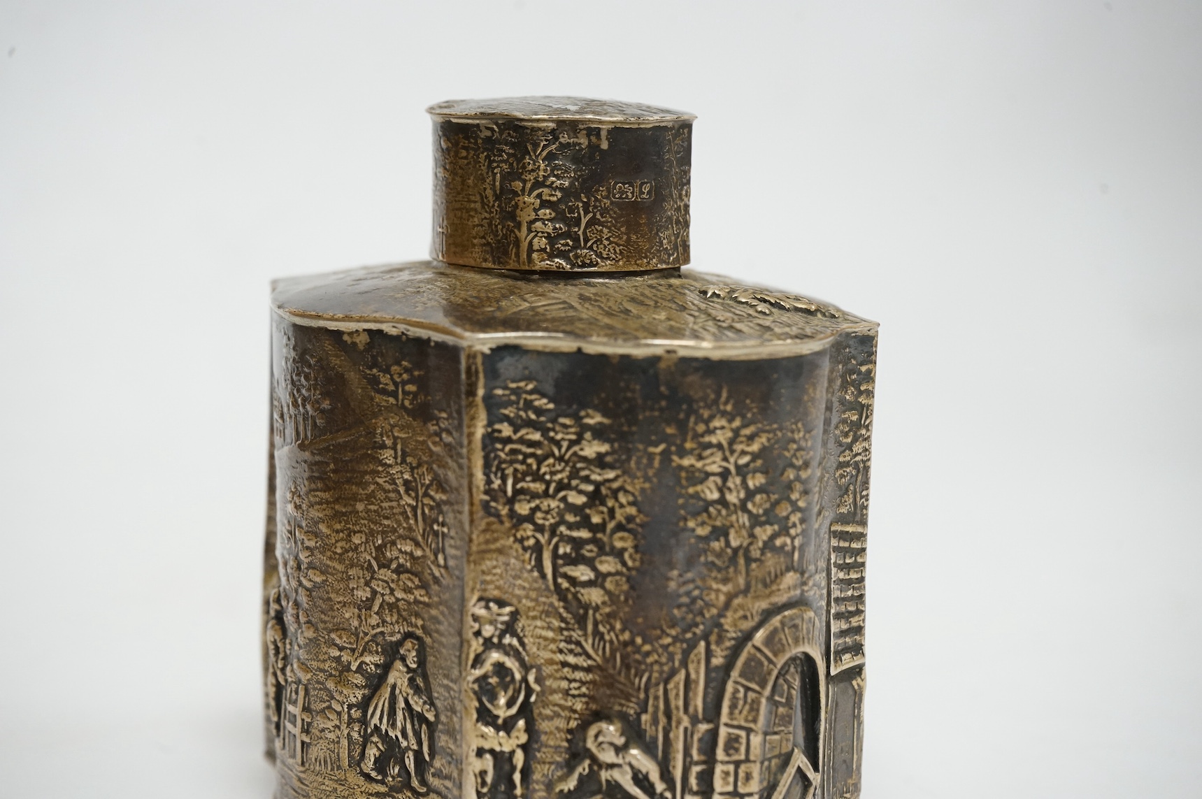 A George V embossed silver serpentine tea caddy, by HF, Chester, 1911, height 98mm, 6.3oz. Condition - fair